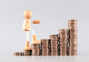 The wooden man goes up and the coins increase