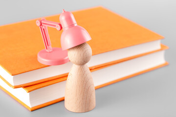 The wooden man is being charged by the book