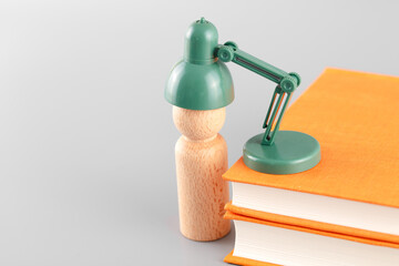 The wooden man is being charged by the book