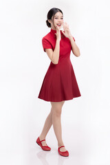 Full body portrait of joyful beauty Asian woman in red Cheongsam Chinese traditional dress celebrating and announcing isolated on white background.