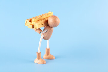 The model of the small house overpowered the wooden man