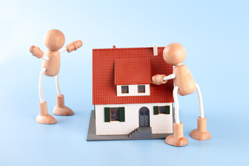 Two wooden people were arguing about the house