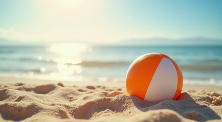 Beach ball on the sand near the ocean