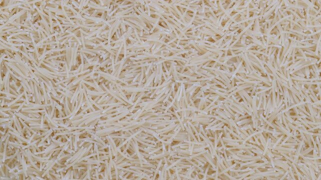 Top down view. Pile of uncooked vermicelli pasta. Slider shot. Pasta dishes, Mediterranean food, Italian cuisine, cooking concepts. 4k