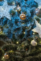 A beautiful close-up of holiday ornaments and frosted pine, celebrating festive warmth. Ideal for ads, Christmas branding, or winter-themed designs.