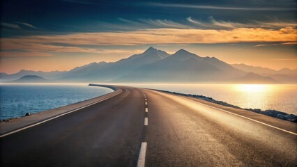Naklejka premium Asphalt road curving along a tranquil ocean coastline at sunset, with majestic mountains in the background creating a scenic and peaceful journey.
