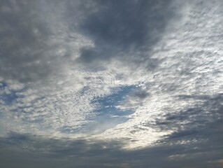 Fototapeta premium Dramatic dark clouds and blue sky in the morning. Natural background texture 