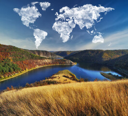 clouds in the form of a world map over the river canyon. Travel and landscape concept. autumn morning