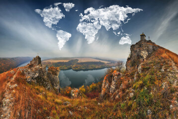 clouds in the form of a world map over the river canyon. Travel and landscape concept. autumn morning