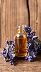 Small bottle with essential oil and lavender flowers. Aromatherapy, homemade spa, beauty treatment concept. Old wooden background, copy space, flat design, with white tones