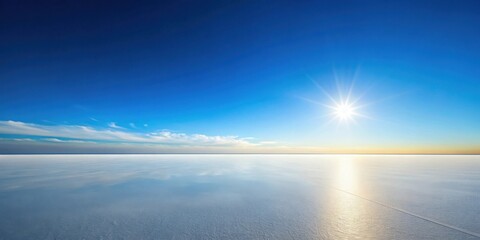 Serene winter landscape featuring a vast expanse of ice reflecting the bright sun and a clear blue sky