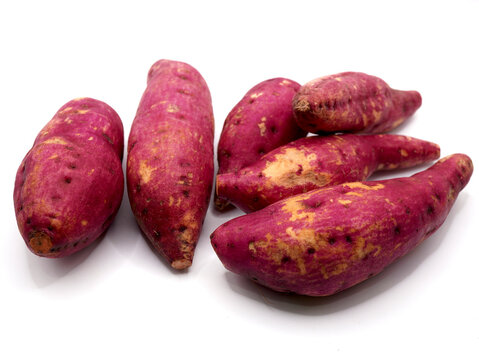 Red-skinned sweet potatoes or red yams or ubi jalar merah isolated on a clean white background