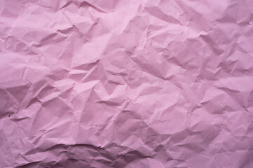 Fototapeta premium Full frame shot of crumpled pink paper sheet texture and background.