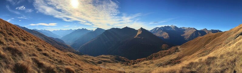 Naklejka premium Panoramic view of majestic mountains under a bright blue sky.