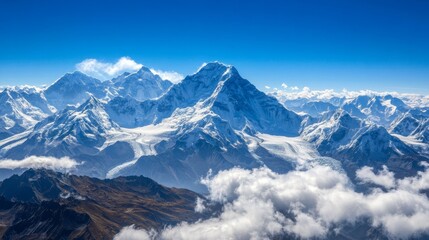 Fototapeta premium A breathtaking view of snow-capped mountains under a clear blue sky.