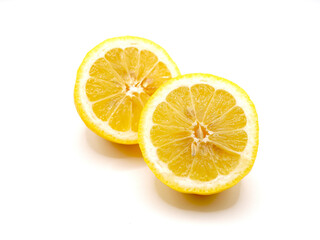 A close-up of lemon slices arranged on a clean white background, showcasing their vibrant yellow hues and juicy texture