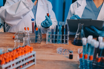 Blood test in the laboratory. Laboratory assistant working with the dispenser. Vacuum tubes with...