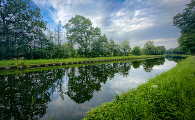 A breathtaking, picturesque view of a calm, serene river winding gently through vibrant trees...