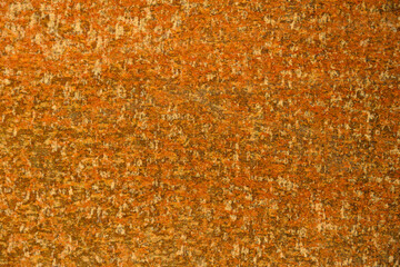 Closeup rust detail in bright orange, as a textured oxidized metal abstract background
