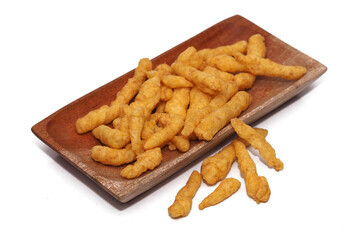 Cheese Puff Snacks on a wooden plate isolated on white background