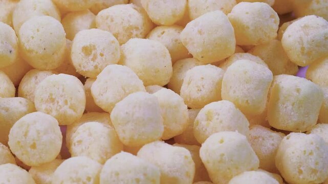 Stack of crispy puffed corn chips. Slider shot. Snacks and Appetizers, Junk Food, Party Treats concepts. 4k