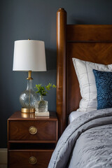 Wooden Bed Frame, Nightstand, and Table Lamp with Greenery