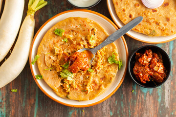 Mooli paratha is a stuffed Indian flatbread made with grated radish, whole wheat flour, and spices, offering a flavorful, nutritious, and wholesome meal.
