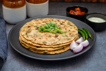Methi paratha is a savory Indian flatbread made with fenugreek leaves, whole wheat flour, spices, and ghee, offering a flavorful, aromatic, and nutritious meal.