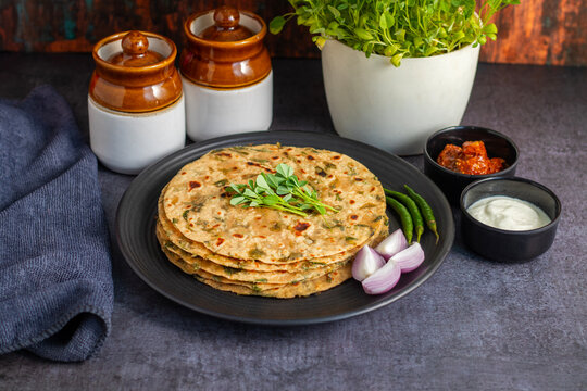 Methi paratha is a savory Indian flatbread made with fenugreek leaves, whole wheat flour, spices, and ghee, offering a flavorful, aromatic, and nutritious meal.