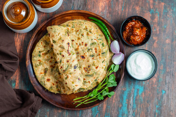 Methi paratha is a savory Indian flatbread made with fenugreek leaves, whole wheat flour, spices, and ghee, offering a flavorful, aromatic, and nutritious meal.