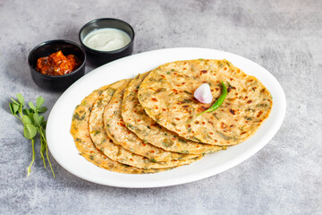 Methi paratha is a savory Indian flatbread made with fenugreek leaves, whole wheat flour, spices, and ghee, offering a flavorful, aromatic, and nutritious meal.