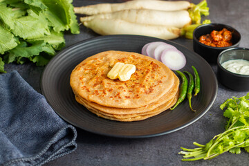 Mooli paratha is a stuffed Indian flatbread made with grated radish, whole wheat flour, and spices, offering a flavorful, nutritious, and wholesome meal.