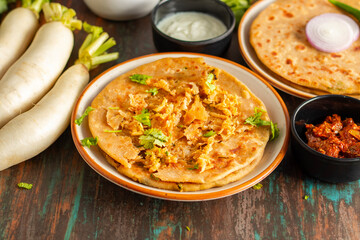 Mooli paratha is a stuffed Indian flatbread made with grated radish, whole wheat flour, and spices, offering a flavorful, nutritious, and wholesome meal.