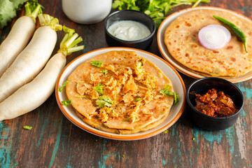 Mooli paratha is a stuffed Indian flatbread made with grated radish, whole wheat flour, and spices, offering a flavorful, nutritious, and wholesome meal.