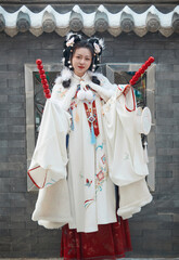 Asian girl wearing Ming Dynasty Hanfu outdoors after heavy snow