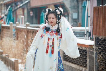 Obraz premium Asian girl wearing Ming Dynasty Hanfu outdoors after heavy snow