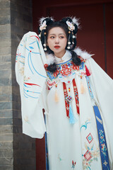 Asian girl wearing Ming Dynasty Hanfu outdoors after heavy snow