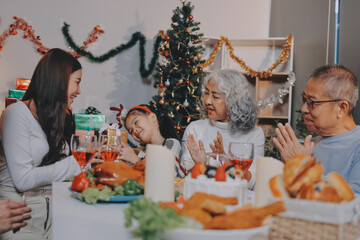 Portrait of Asian family exchanging presents during christmas at home. Attractive happy people holding gift box, celebrate holiday thanksgiving, xmas eve tradition in living room in house together.