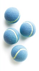 Fototapeta premium Four Playful Blue Tennis Balls on a White Background. Perfect for Sports Enthusiasts and Outdoor Activities. Ideal for Tennis, Playgrounds, and Games. A Great Addition to Any Sports Collection.