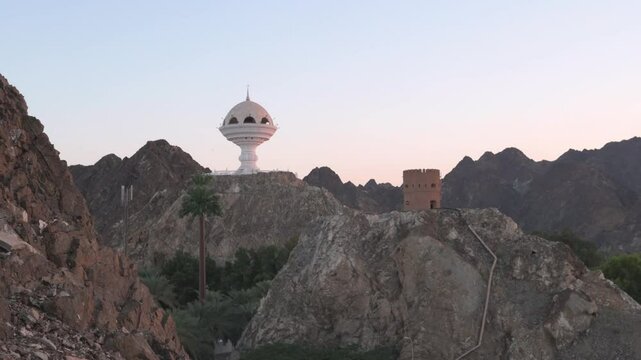 Riyam Incense Burner Monument in Muscat, Oman at Sunset with Mountainous Backdrop