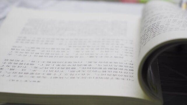 Learning to read with an empty camera focusing on books and a close-up of the reading process in a quiet environment