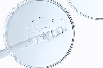 The texture of a cosmetic serum or body gel in a Petri dish.