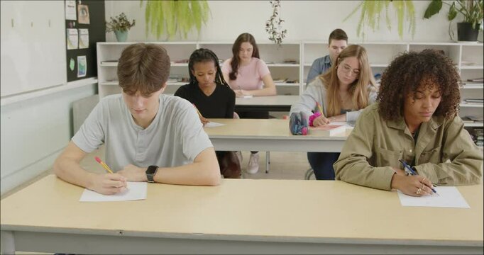 High School - College Students Writing Assignment Essay. Academic Studies. Diverse Male and Female Students Write Notes, Study, Mid Term Final Exam Test Answers in Class. Educational Learning Course