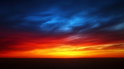 Obraz premium Vibrant Sunset Sky Over Silhouetted Landscape