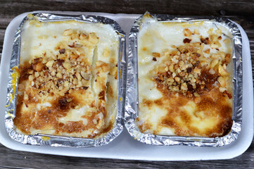 Baked butternut honey nut squash, pumpkin, gramma, with milk, sugar, mixed nuts, whipped cream and corn flour, a baked sweet dessert in the oven, then chilled and preserved in 2 to 5 degree centigrade
