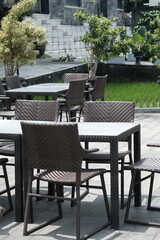 rattan and wooden chair table set. natural tropical style terrace. a place to relax.