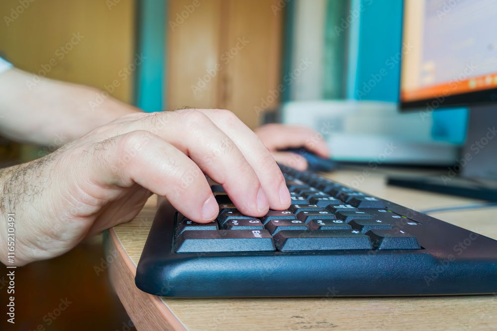 Poster close-up of a man's hand typing on a computer keyboard