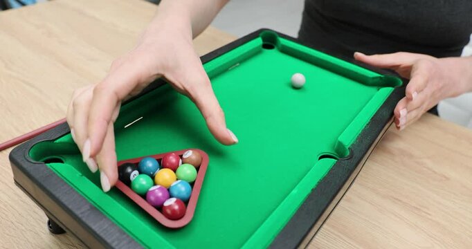Miniature pool table with colorful balls on a green table