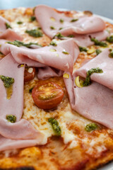 Close-up of a pizza with mortadella and arugula