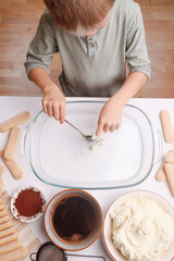 A child making homemade tiramisu